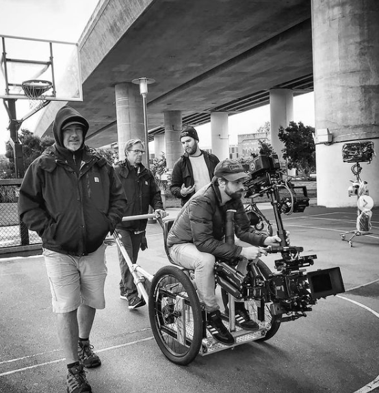 Nick Schwyter operating a stabilized camera from a wheelchair during an Apple AirPods production.