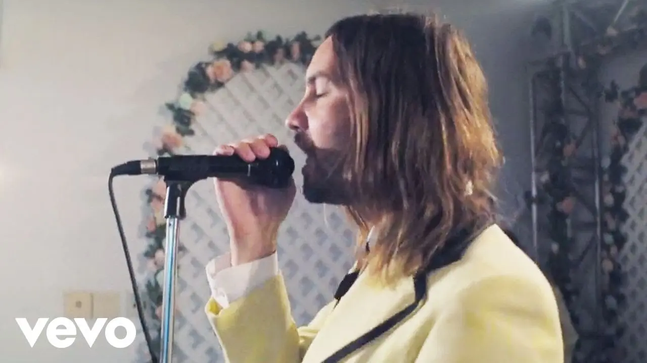 Kevin Parker performing in a warmly lit room from Tame Impala's Lost in Yesterday video.